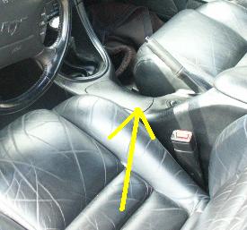 1998 Ford Mustang - Interior view of a car's center console and seats, with a yellow arrow indicating a specific area.