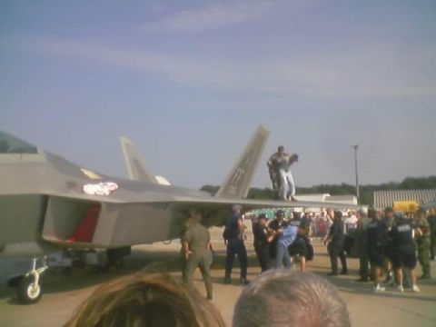 1989 Ford Bronco - A fighter jet is on display with people interacting around it and a crowd observing.