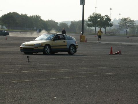 2001 Mercury Grand Marquis - Honda CRX participating in an autocross event in a parking lot.