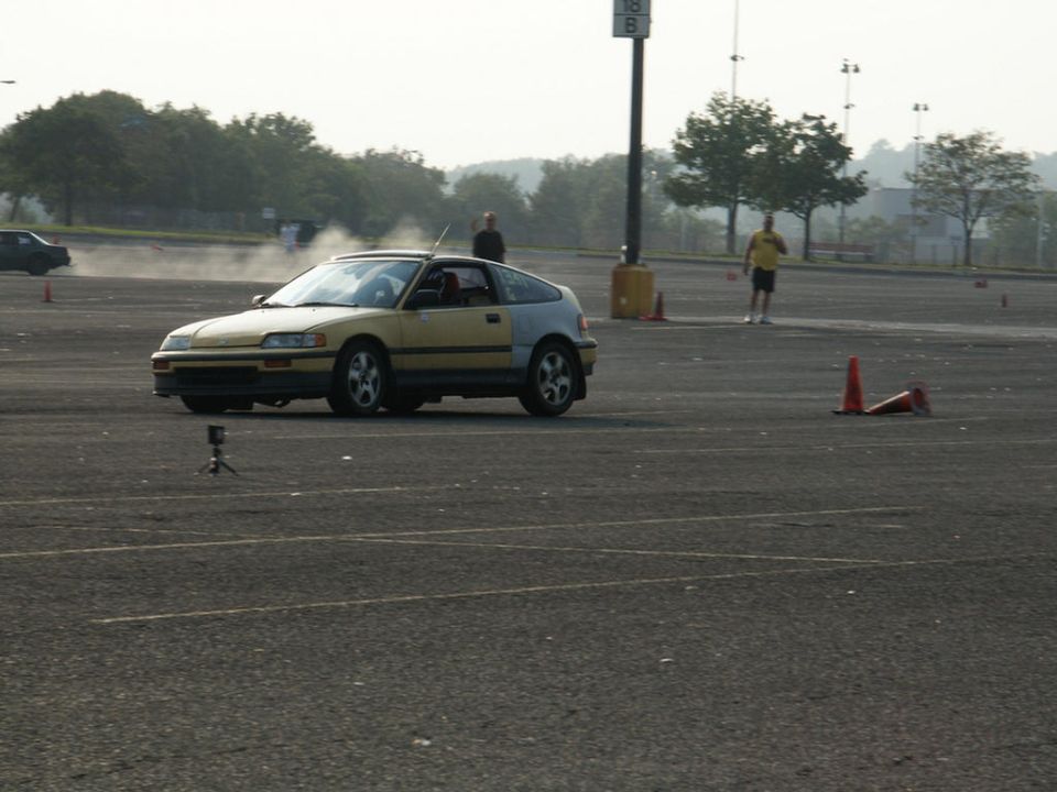Yellow and silver Honda CRX in a parking lot with cones