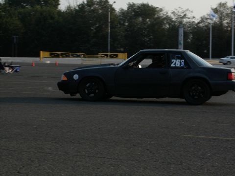 2001 Mercury Grand Marquis - A black coupe with racing number 26 is seen on a track, possibly during an event.