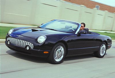 2002 Ford Thunderbird - Black 2002 Ford Thunderbird convertible driving on a road with a driver.