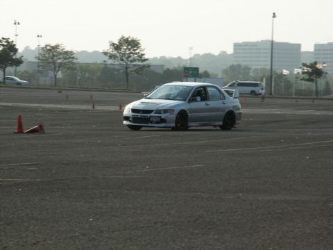 2001 Mercury Grand Marquis - Silver Mitsubishi Lancer Evolution seen on a track with orange cones.