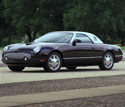 2002 Ford Thunderbird - A black 2002 Ford Thunderbird convertible with a white hardtop is parked on a paved surface.