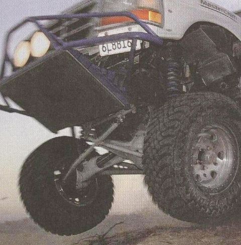 1984 Ford Bronco - This modified truck features aggressive off-road tires and a reinforced front bumper with auxiliary lighting.