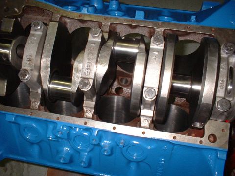 1969 Ford Mustang - Close-up view of engine crankshaft and connecting rods, showing part numbers stamped on the components.