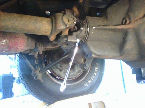 1989 Ford Bronco - unfasten the ubolts and detach the driveshaft from the rear axel.