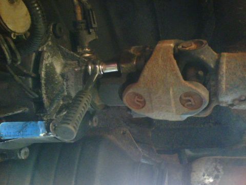 1989 Ford Bronco - unfasten the bolts and detach the driveshaft dual u-jount assembly from the transfercase. (note: the bolt heads are a 10 or 12 pointed head…