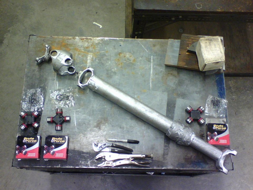 here is the driveshaft all disassembled with the new  parts ready to be put in.   The part numbers for the dual u-joint end of the drive shaft are 2-4800BF and from the single u-joint end it is 2-4900BF both from auto zone.  The main difference I saw between the 4800 and 4900 is the 4800 has all endcaps the same size O.D. and on the 4900 one axis endcaps are bigger than the others.