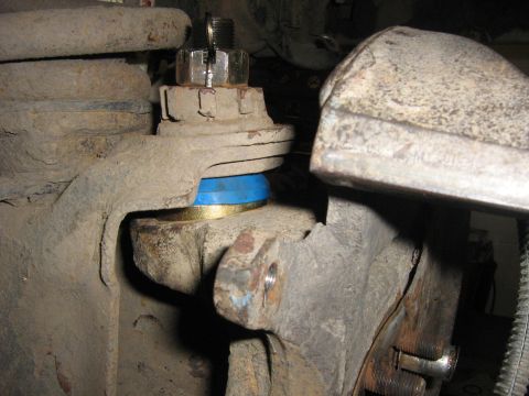 1995 Ford Bronco - This image shows a close-up view of a vehicle's suspension system, specifically focusing on a ball joint assembly.