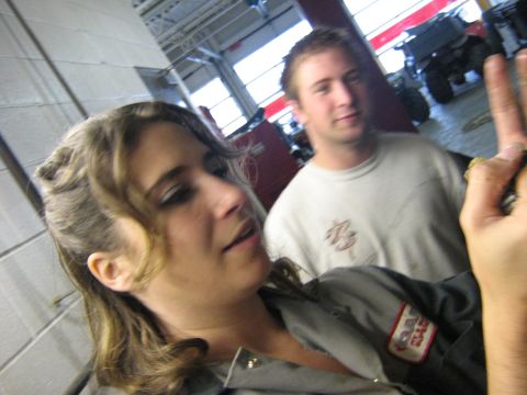 1995 Ford Bronco - A woman and a man are in a garage, with the woman in the foreground and the man behind her.