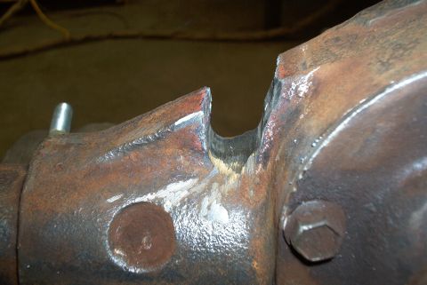 1983 Ford Bronco - This image shows a close-up of a rusted metal part with a distinct notch.