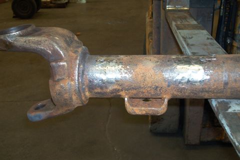 1983 Ford Bronco - Close-up of a heavily rusted driveshaft component, likely for a truck or SUV.