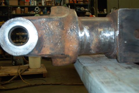 1983 Ford Bronco - A close-up view of a large, rusty metal part, possibly a component from heavy machinery or a vehicle axle.