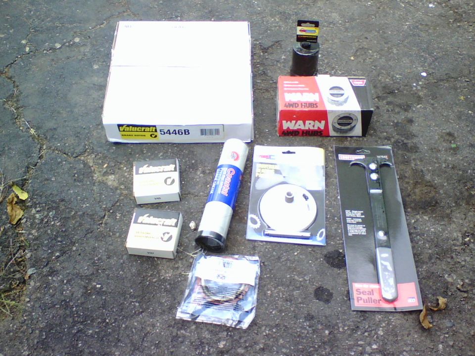 After replacing my U-joints and the loud hum was gone I started to hear the other noises and vibrations. Like my wheel bearings in the front drivers side.    since I was going to replace my wheel bearings it seemed a good time to replace the grooved brake rotor and swap my auto hubs with new manual WARN hubs.   I got the rotor and bearings at AZ , they didnt have the Warn hubs in stock so I went to NAPA for them.   

Some of the tools required were a special bearing adj/lock nut socket,  torx driver,  an arbor press, bearing puller, bearing seal puller and a slide hammer or dent puller.