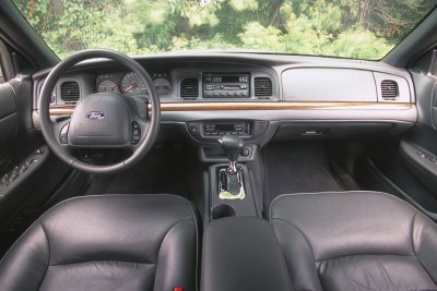 2002 Ford Crown Victoria - Interior view of a 2002 Ford Crown Victoria, showing the dashboard, steering wheel, and front seats.