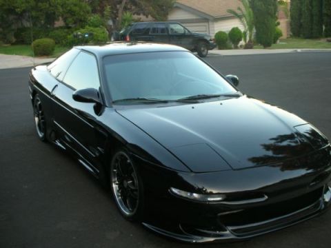 1994 Ford Probe - A black 1994 Ford Probe is shown from a 3/4 front angle.