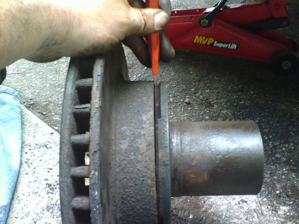 using the beveled edge inbetween the hub and rotor I separated the two.