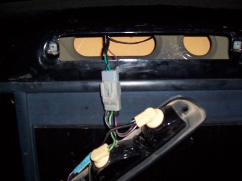 2003 Ford Ranger - Close-up of a vehicle's wiring harness and a light socket assembly.