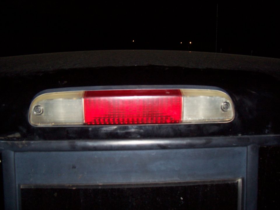 Close-up of a vehicle's third brake light at night