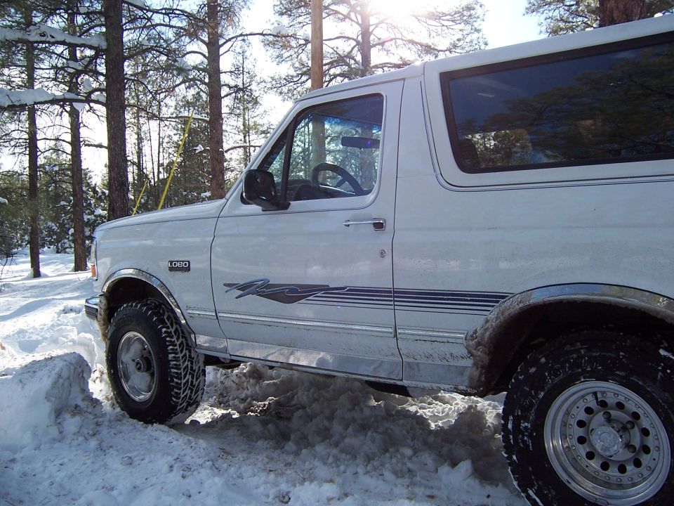 White 1996 Ford Bronco side view in snowy woods
