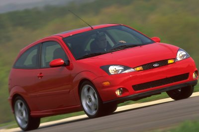 2002 Ford Focus - Red 2002 Ford Focus SVT hatchback captured in motion on a paved road.