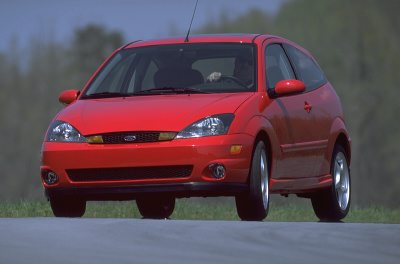 2002 Ford Focus - A red 2002 Ford Focus SVT is shown from a three-quarter front view on a paved surface with a blurred background.