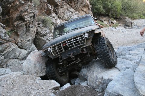 1966 Ford Bronco - This 1966 Ford Bronco is shown navigating a challenging rocky trail, demonstrating its off-road capabilities.
