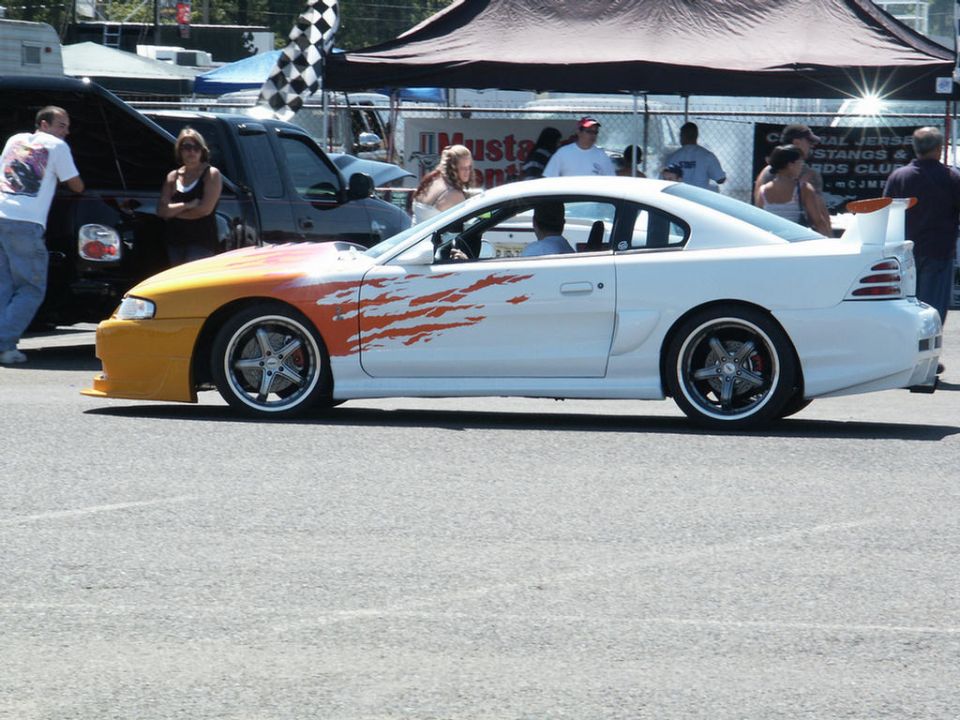 White coupe with flame decals, side view. 1994 model