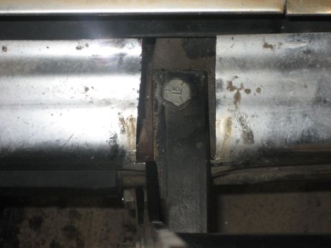 1986 Ford Bronco - A detailed view of a vehicle's undercarriage components, revealing structural elements and fasteners.