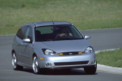 2002 Ford Focus - Silver 2002 Ford Focus hatchback captured in a front 3/4 view on a paved road.