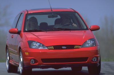 2002 Ford Focus - Front view of a red 2002 Ford Focus SVT hatchback on the road.