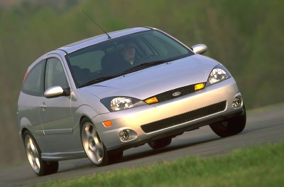 2002 Ford Focus - Silver hatchback with a black grille and yellow turn signals is shown from a 3/4 front angle on a road.