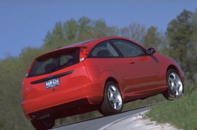 2002 Ford Focus - Rear view of a red 2002 Ford Focus SVT hatchback on the road.
