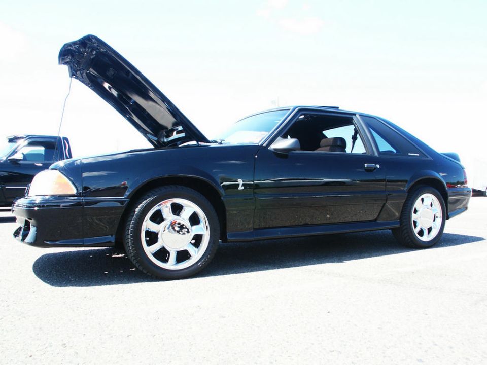 Black coupe with hood open, chrome wheels, 1993 model
