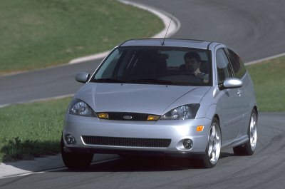 2002 Ford Focus - Silver 2002 Ford Focus hatchback driving on a track, showing its front and side profile.