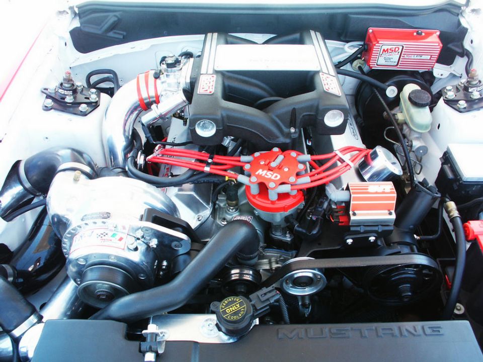 Engine bay with a supercharger, MSD ignition, and custom intake