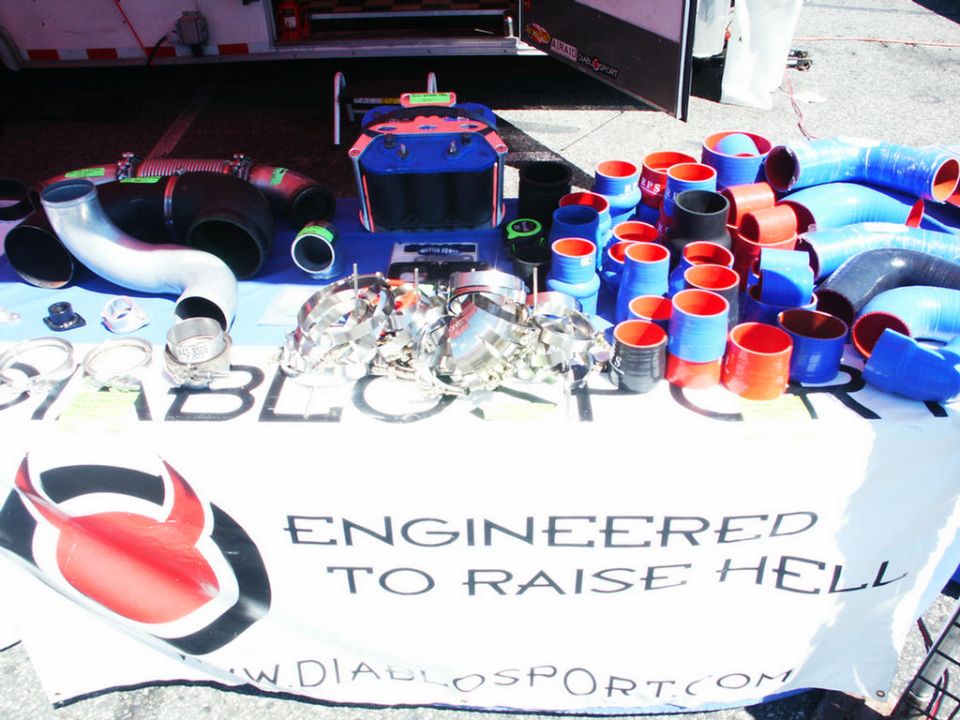 Table with assorted blue, red, and black silicone hoses and metal clamps