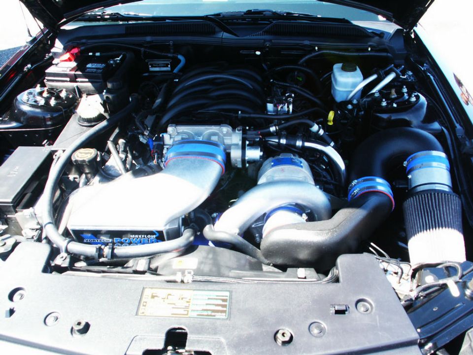 Engine bay with supercharger, intake, and air filter. Text on a box reads 'MAXFLOW POWER'