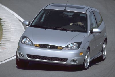2002 Ford Focus - A silver hatchback car is captured from a 3/4 front view on a paved surface, with visible text at the bottom right.