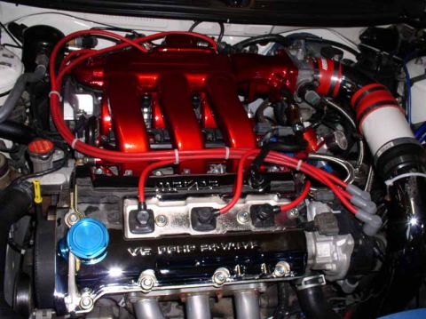 1996 Ford Probe - Close-up of a modified V6 engine bay with prominent red intake runners.