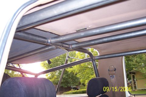 1989 Ford Bronco - Custom roll cage installed inside the vehicle's interior, with a view of the seats and headrests.