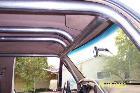 1989 Ford Bronco - Custom roll cage installed inside a vehicle's interior.