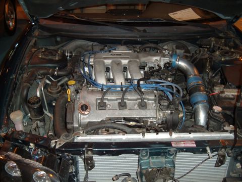 1991 Ford Probe - The engine bay of a 1991 Ford Probe is visible, showing its V6 engine and various components.