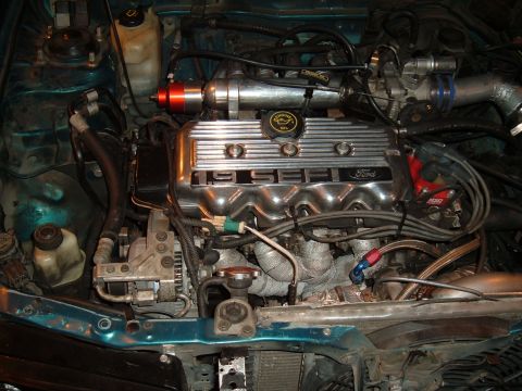 1991 Ford Probe - Close-up of a 1991 Ford Probe engine bay, highlighting the 1.9L SEFI engine and aftermarket turbo modifications.