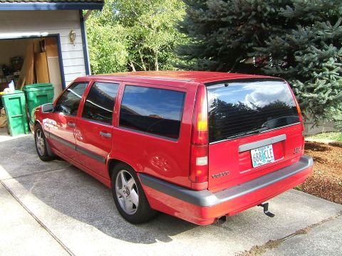 1987 Volkswagen Golf - This red Volvo station wagon is parked in a driveway, showing its rear 3/4 profile.