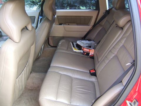 1987 Volkswagen Golf - Rear interior view of a car with beige leather seats and boxes on the seat.