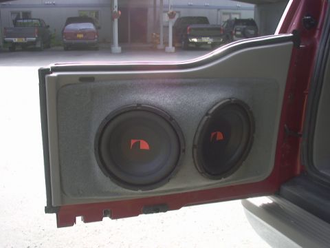 2000 Ford Excursion - Custom car door panel with dual subwoofers visible.