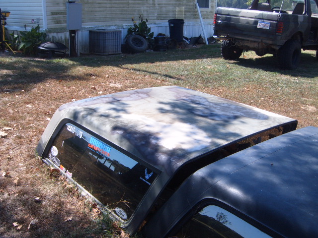 Camouflaged Bronco hardtop with stickers, including 'Bronco' text