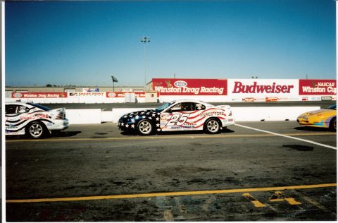 1995 Ford Mustang - Race cars line up on the drag strip, with Winston Drag Racing and Budweiser banners visible.